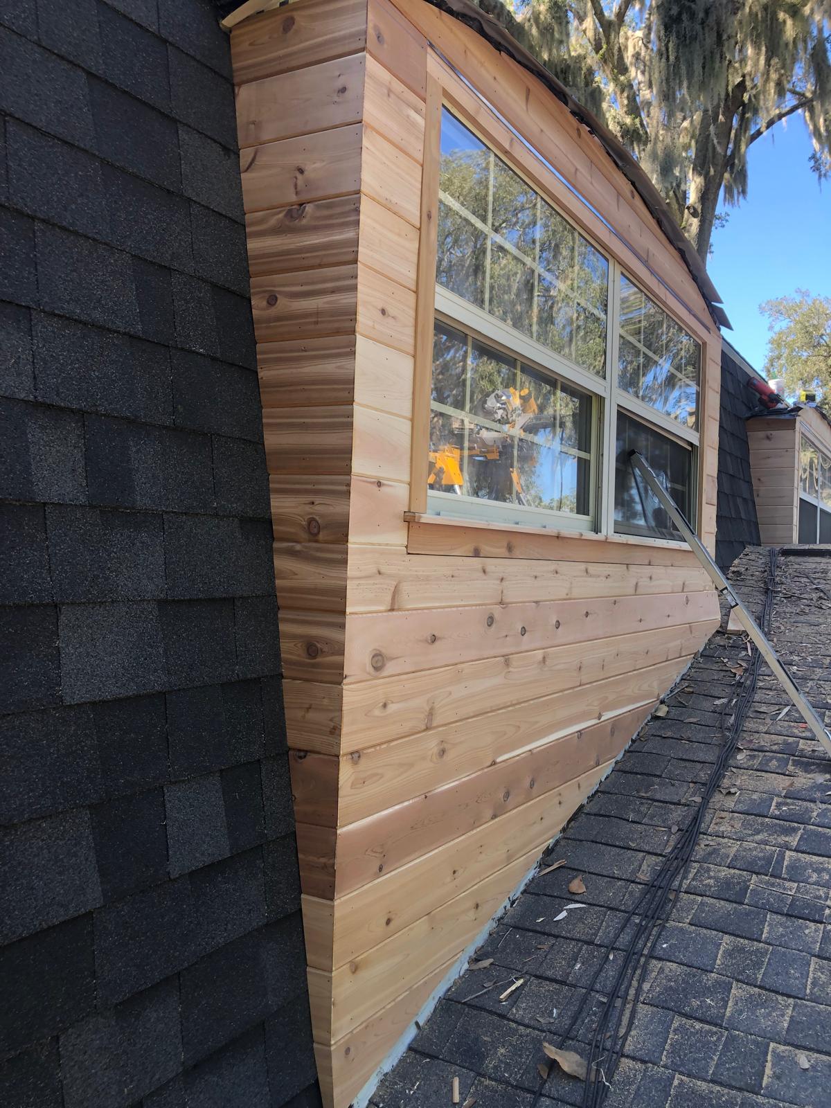 Close-up of finished exterior dormer wood cladding and window trim